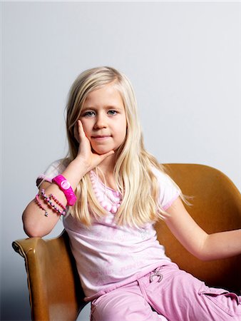 Girl sitting on chair Stock Photo - Premium Royalty-Free, Code: 6102-03905899