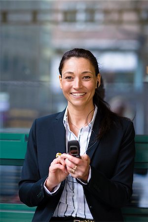 simsearch:6102-07455789,k - Portrait of cheerful businesswoman text messaging Stock Photo - Premium Royalty-Free, Code: 6102-04929593