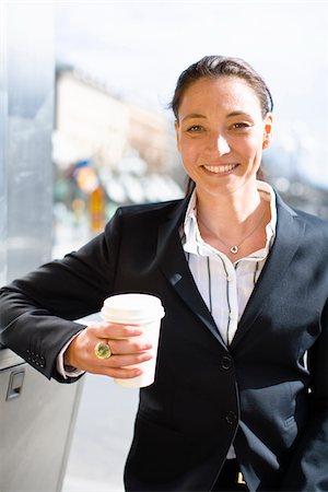 simsearch:6102-07455789,k - Portrait of cheerful businesswoman with takeaway coffee Stock Photo - Premium Royalty-Free, Code: 6102-04929591