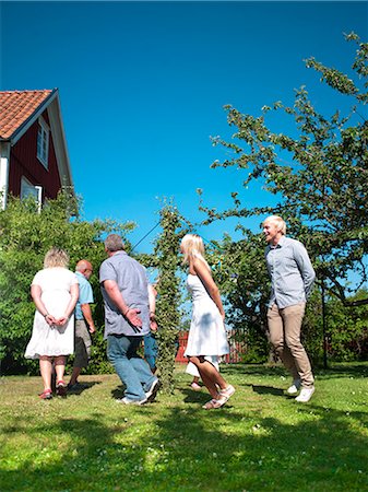 Family dancing around maypole in garden Stock Photo - Premium Royalty-Free, Code: 6102-05655420