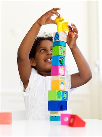 Girl building tower out of bocks Stock Photo - Premium Royalty-Free, Code: 6102-05802510