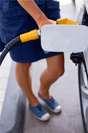 Woman filling car with gas Stock Photo - Premium Royalty-Free, Code: 6102-05802603