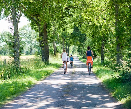 family on bikes - Mother with daughters cycling on rural road Stock Photo - Premium Royalty-Free, Code: 6102-05802613