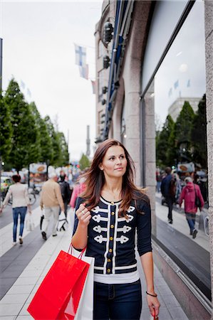 shopping bags city street - Woman with shopping bag walking in street Stock Photo - Premium Royalty-Free, Code: 6102-06025953