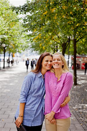 Two friends embracing in park Stock Photo - Premium Royalty-Free, Code: 6102-06025936