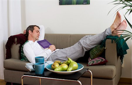 Mid adult man lying on sofa and sleeping Stock Photo - Premium Royalty-Free, Code: 6102-06026023