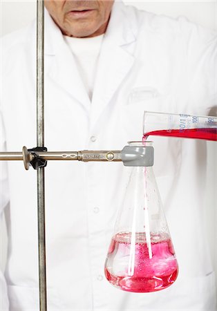 Scientist pouring chemical into beaker, mid section Stock Photo - Premium Royalty-Free, Code: 6102-06336732