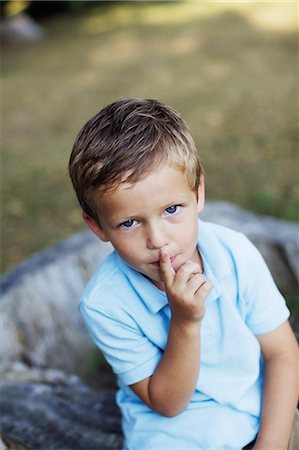 silence - Portrait of boy with finger on lips Stock Photo - Premium Royalty-Free, Code: 6102-06336876