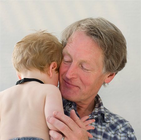 shy baby - A father hugging his little son. Stock Photo - Premium Royalty-Free, Code: 6102-06470651