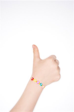 Childrens hand showing thumb up, studio shot Stock Photo - Premium Royalty-Free, Code: 6102-06471048