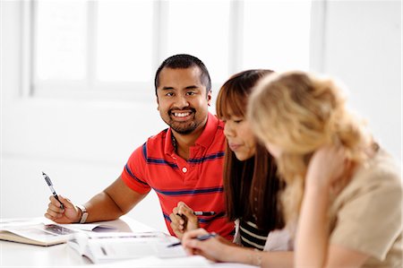 Happy students studying in library Stock Photo - Premium Royalty-Free, Code: 6102-06471113