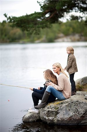 Mother with two kids fishing at lake Stock Photo - Premium Royalty-Free, Code: 6102-06777366