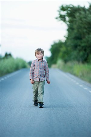 sweden blond boy - Boy walking on road Stock Photo - Premium Royalty-Free, Code: 6102-06777422