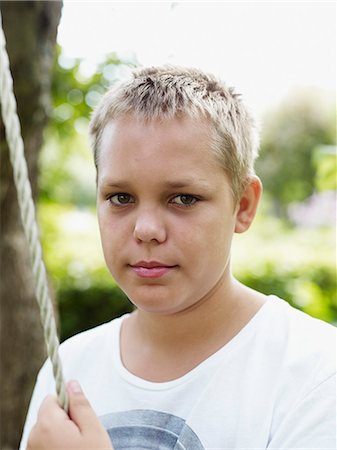 simsearch:6102-06965505,k - Portrait of teenage boy holding rope Stock Photo - Premium Royalty-Free, Code: 6102-06965498