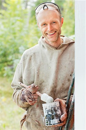 simsearch:6102-06965474,k - Smiling man holding can of paint Stock Photo - Premium Royalty-Free, Code: 6102-06965433