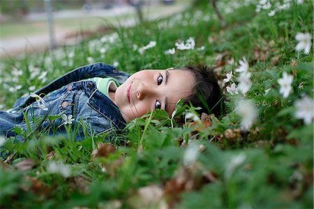 simsearch:6102-06965474,k - Smiling boy lying in grass Stock Photo - Premium Royalty-Free, Code: 6102-06965581