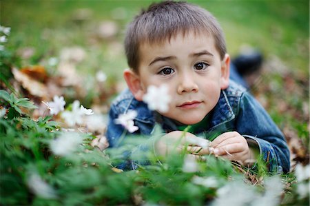 simsearch:6102-06965474,k - Smiling boy lying in grass Stock Photo - Premium Royalty-Free, Code: 6102-06965585