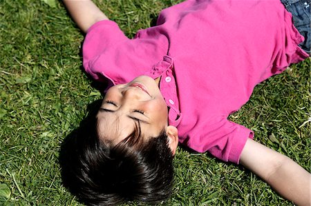 simsearch:6102-06965505,k - Smiling boy lying on grass Stock Photo - Premium Royalty-Free, Code: 6102-06965589