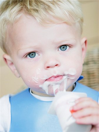 simsearch:6102-06965474,k - Boy eating yoghurt Stock Photo - Premium Royalty-Free, Code: 6102-06965535