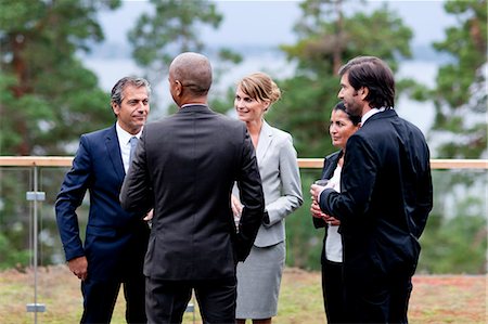 simsearch:6102-06965505,k - Businessmen and businesswomen discussing outdoors Stock Photo - Premium Royalty-Free, Code: 6102-06965724