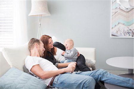 person in room - Happy parents with son on sofa Stock Photo - Premium Royalty-Free, Code: 6102-07158100