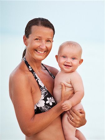 Mother with baby looking at camera, Thailand Stock Photo - Premium Royalty-Free, Code: 6102-07602782