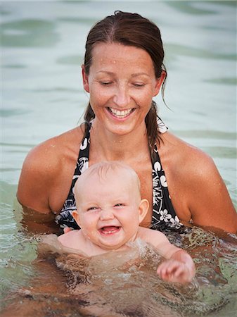 Mother with baby bathing in sea, Thailand Stock Photo - Premium Royalty-Free, Code: 6102-07602784