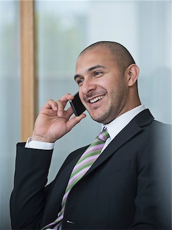 simsearch:6102-07455789,k - Businessman using cell phone Stock Photo - Premium Royalty-Free, Code: 6102-07602724