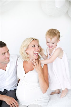 simsearch:673-06964589,k - Parents playing with daughter on bed, studio shot Stock Photo - Premium Royalty-Free, Code: 6102-07768642