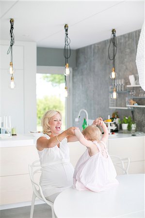 simsearch:6102-08566788,k - Pregnant woman playing with daughter, Stockholm, Sweden Stock Photo - Premium Royalty-Free, Code: 6102-07768658