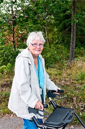 Senior woman with walking frame, Vastervik, Smiland, Sweden Stock Photo - Premium Royalty-Free, Code: 6102-07768803