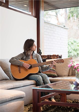 Teenage girl playing guitar Stock Photo - Premium Royalty-Free, Code: 6102-07769405