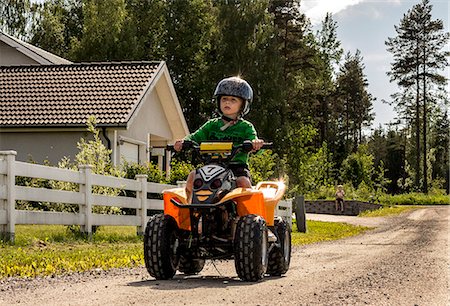 Boy on four-wheeler, Orebro, Sweden Stock Photo - Premium Royalty-Free, Code: 6102-07789502