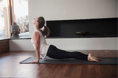 person in room - Woman doing yoga at home Stock Photo - Premium Royalty-Free, Code: 6102-07789618