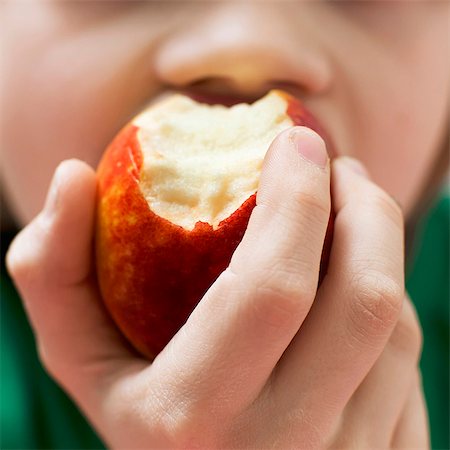 square image - Boy eating apple, close-up Stock Photo - Premium Royalty-Free, Code: 6102-07789960