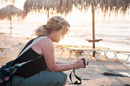 Woman on beach looking at camera Stock Photo - Premium Royalty-Free, Code: 6102-07790136