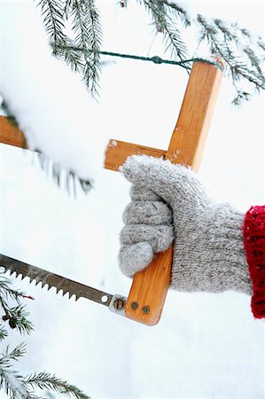 sawing - Hand holding saw, close-up Stock Photo - Premium Royalty-Free, Code: 6102-07842656