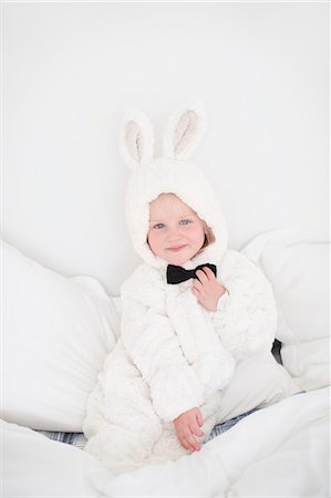 simsearch:6102-07455789,k - Girl wearing rabbit costume sitting on bed Stock Photo - Premium Royalty-Free, Code: 6102-07842738