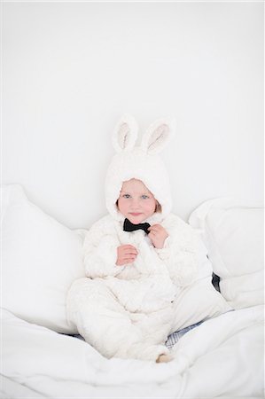 simsearch:6102-07455789,k - Girl wearing rabbit costume sitting on bed Stock Photo - Premium Royalty-Free, Code: 6102-07842739