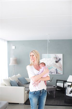 pictures of new born baby rooms - Woman holding newborn daughter Stock Photo - Premium Royalty-Free, Code: 6102-07843444