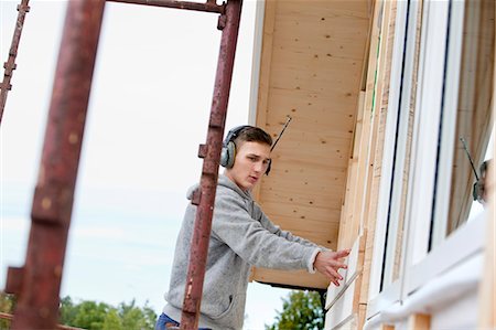 simsearch:6102-07158067,k - Young man building house Stock Photo - Premium Royalty-Free, Code: 6102-07843405