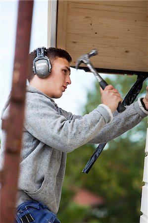 Young man with hammer Stock Photo - Premium Royalty-Free, Code: 6102-07843406