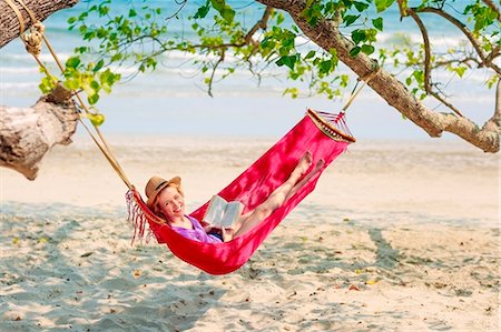 Young woman relaxing in hammock on beach Stock Photo - Premium Royalty-Free, Code: 6102-07843875