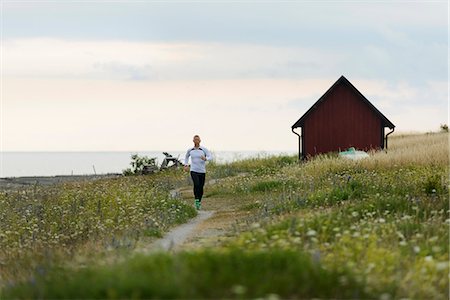 simsearch:6102-08120697,k - Young man running through meadow Foto de stock - Sin royalties Premium, Código: 6102-07844054