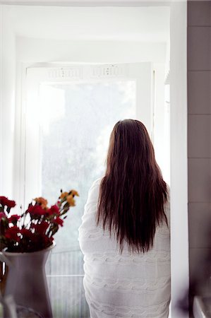 doorway - Woman wrapped in blanket standing looking through window Stock Photo - Premium Royalty-Free, Code: 6102-08062964