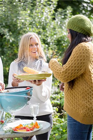 Young women having barbecue in garden Stock Photo - Premium Royalty-Free, Code: 6102-08000724