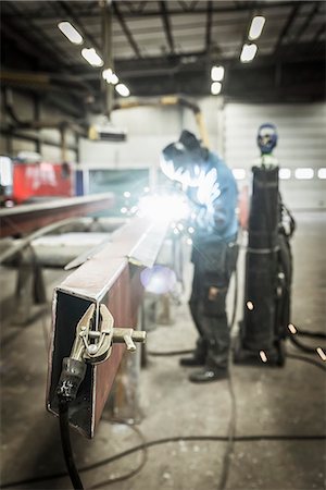 Clamp on metal structure, man welding on background Stock Photo - Premium Royalty-Free, Code: 6102-08183994