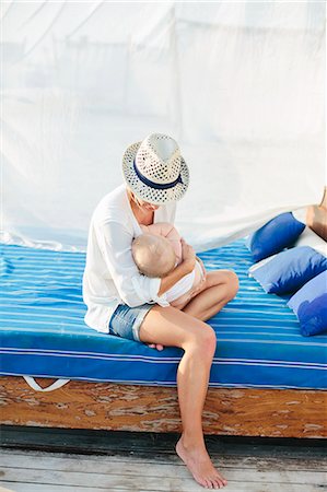 sunhat - Mother with baby playing on outdoor bed Stock Photo - Premium Royalty-Free, Code: 6102-08120356