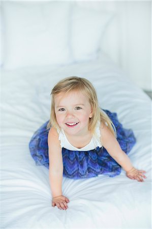 Girl playing on bed Stock Photo - Premium Royalty-Free, Code: 6102-08120376