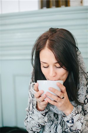 Young woman with cup of coffee Stock Photo - Premium Royalty-Free, Code: 6102-08120396